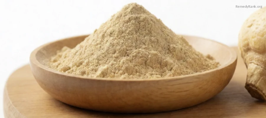 A wooden bowl of tan maca root powder beside a whole dried maca root.