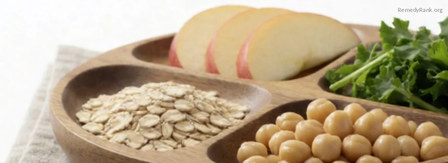 A divided platter with separate small portions of oats, chickpeas, apple slices, and leafy greens.